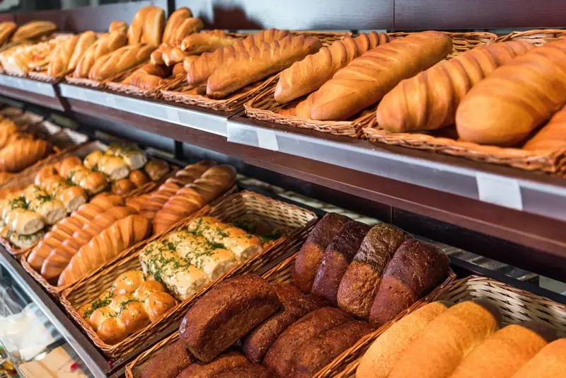 selective focus of freshly baked various bread in pastry department of grocery store.jpg